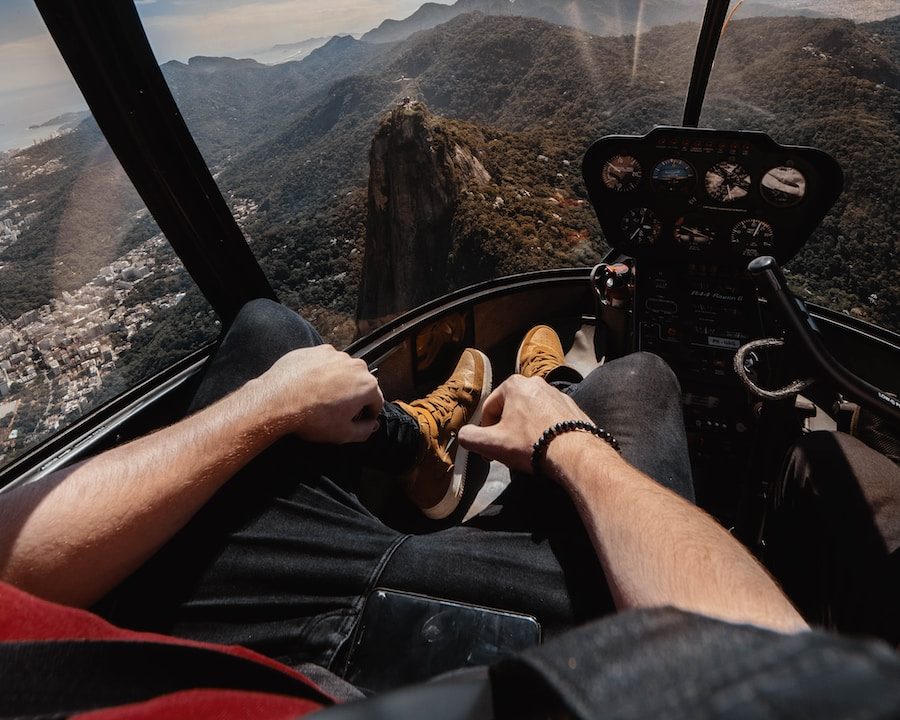 person riding aircraft over the mountain